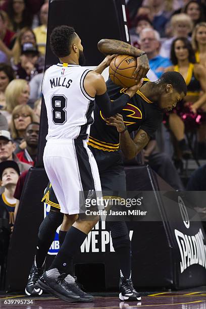 Patty Mills of the San Antonio Spurs and DeAndre Liggins of the Cleveland Cavaliers fight for the ball during the first half at Quicken Loans Arena...