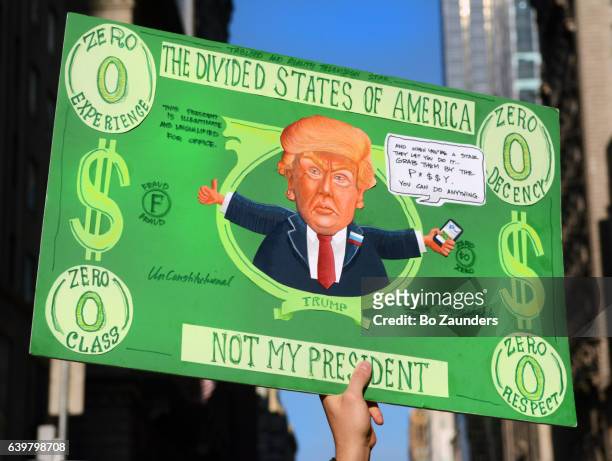 poster in the shape of a zero $ bill, at the women's march rally - donald trump caricature stock pictures, royalty-free photos & images