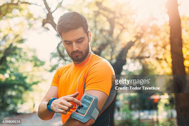 sportsman with an armband - running man heartbeat stock pictures, royalty-free photos & images