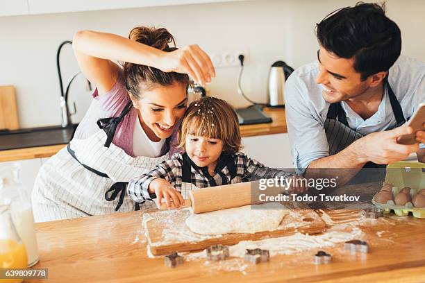 family making cookies in the kitchen - man baking cookies stock pictures, royalty-free photos & images