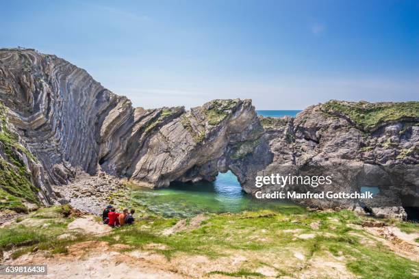 folded limestone strata at stair hole - jurassic coast world heritage site stock pictures, royalty-free photos & images