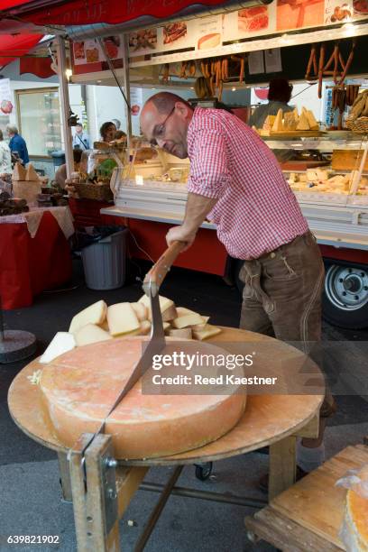 "who cut the cheese?" this austrian cheese shop owner did. - european alps stock pictures, royalty-free photos & images