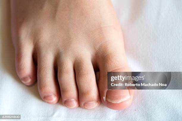 close up of healthy child foot over white background - toenail stock-fotos und bilder