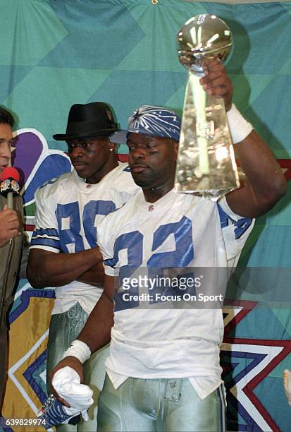 Dallas Cowboys Super Bowl XXVIII Most Valubale Player Emmitt Smith embraces  the Super Bowl trophy in the locker room after the Cowboys defeated the  Buffalo Bills 30-12 at the Georgia Dome in