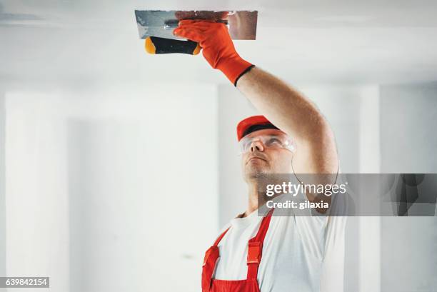 construction worker doing a hard a finish of a ceiling. - ceiling stock pictures, royalty-free photos & images