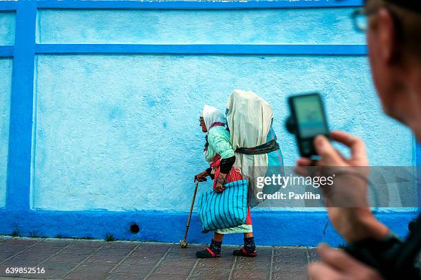 old moroccan woman carrying waste on the back, chefchaouen, morocco - hiding rubbish stock pictures, royalty-free photos & images