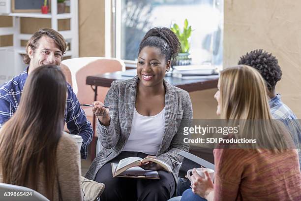 confident african american woman leads bible study - religion stock pictures, royalty-free photos & images