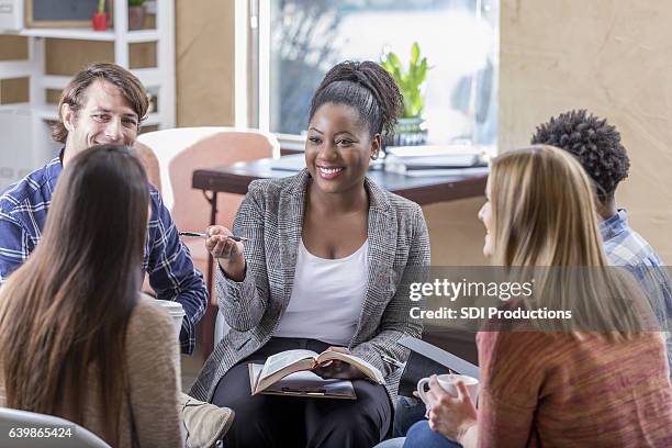 confident african american woman leads bible study - biblical event 個照片及圖片檔