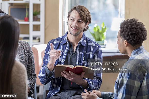 confident mid adult caucasian man participates in bible study - black women in the bible stock pictures, royalty-free photos & images