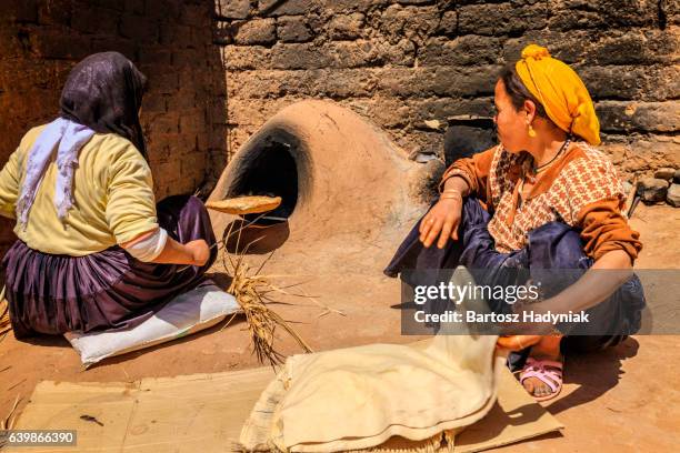 moroccan women baking bread - khubz - tandoor oven stock pictures, royalty-free photos & images