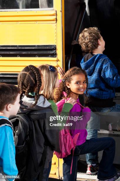 children boarding school bus - boarding school children stock pictures, royalty-free photos & images