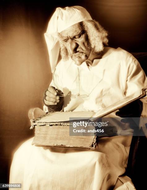 sepia toned image of old fashioned character in nightshirt - ebenezer scrooge stockfoto's en -beelden