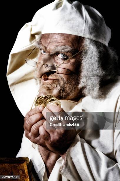 scrooge like victorian character counting money - victorian scrooge stock pictures, royalty-free photos & images