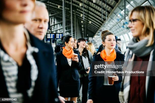 flight attendants and travellers at the airport - airhostess stock pictures, royalty-free photos & images