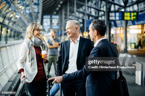 group of mature business people meeting at the airport - viaje de negocios fotografías e imágenes de stock