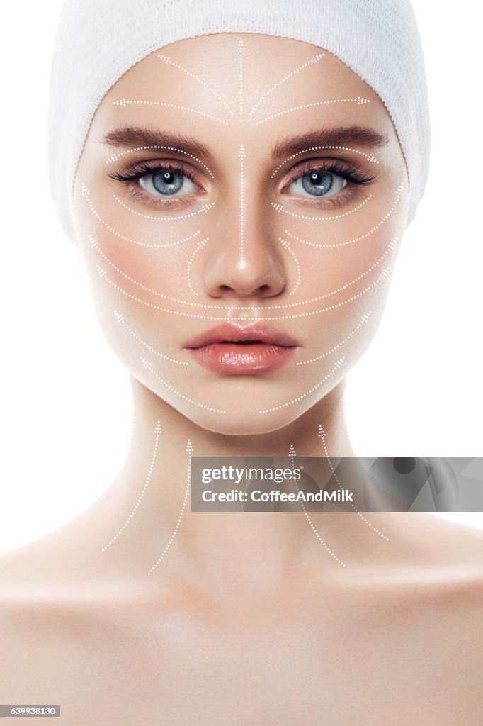 Woman's face with arrows as a model of facial massage