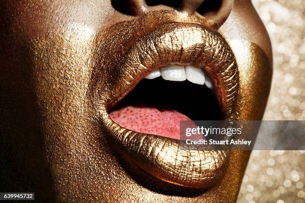 gold beautiful mouth and lips - gold tooth stock-fotos und bilder