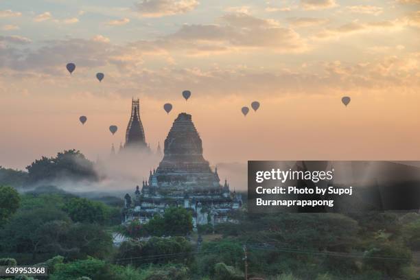 hot air balloon in the morning fog at bagan myanmar - bagan temples damaged in myanmar earthquake stock pictures, royalty-free photos & images