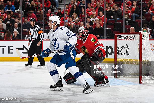 Gabriel Dumont of the Tampa Bay Lightning waits in position in front of goalie Corey Crawford of the Chicago Blackhawks in the second period at the...