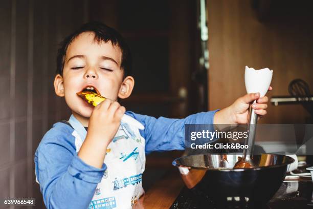 cooking is superb! - kid chef stockfoto's en -beelden