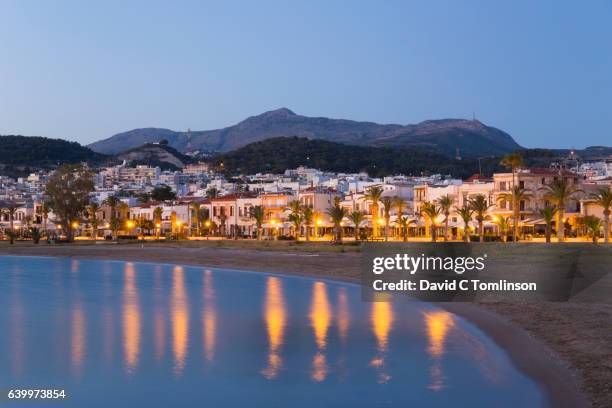 seafront lights reflected in still water, rethymno, crete, greece - urban beach stockfoto's en -beelden