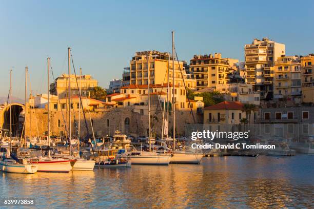 view across the venetian harbour at sunset, iraklio, crete, greece - herakleion stockfoto's en -beelden