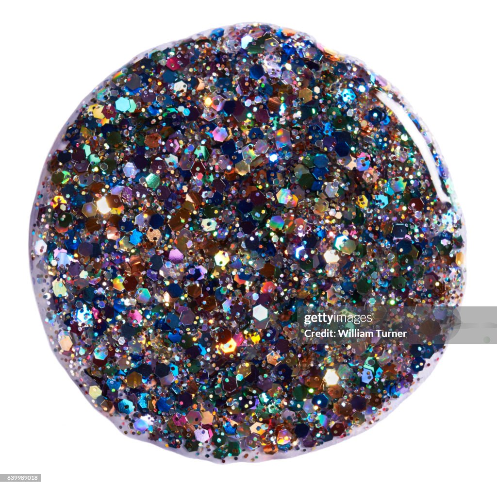 A close-up beauty image of multi-coloured glitter nail polish
