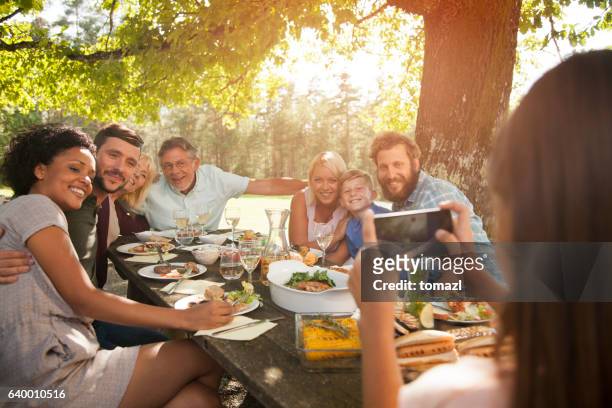 taking a photo of a big family. - baby human age stock pictures, royalty-free photos & images