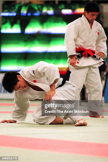 Tadahiro Nomura holds his left knee during his -60kg semifinal against Masato Uchishiba of Japan during day one of the Kano Jigoro Cup Tokyo...