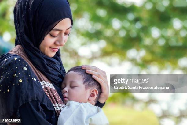 muslim mother and little baby - cute muslim boys stock pictures, royalty-free photos & images