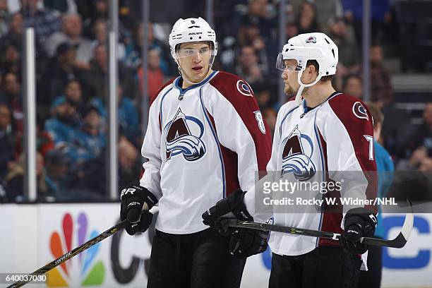 Joe Colborne and John Mitchell of the Colorado Avalanche talk during the game against the San Jose Sharks at SAP Center on January 21, 2017 in San...