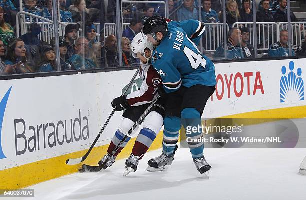 John Mitchell of the Colorado Avalanche skates after the puck against Marc-Edouard Vlasic of the San Jose Sharks at SAP Center on January 21, 2017 in...
