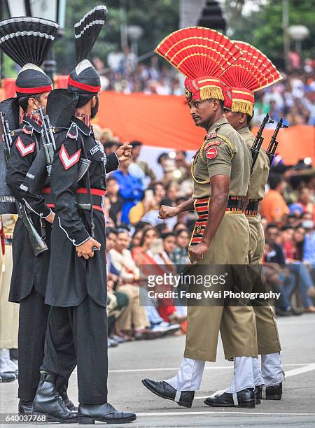 pakistan and indian soldiers showing "intimidating" gesture @ wagah border ceremony, august 2015 - wagah stockfoto's en -beelden