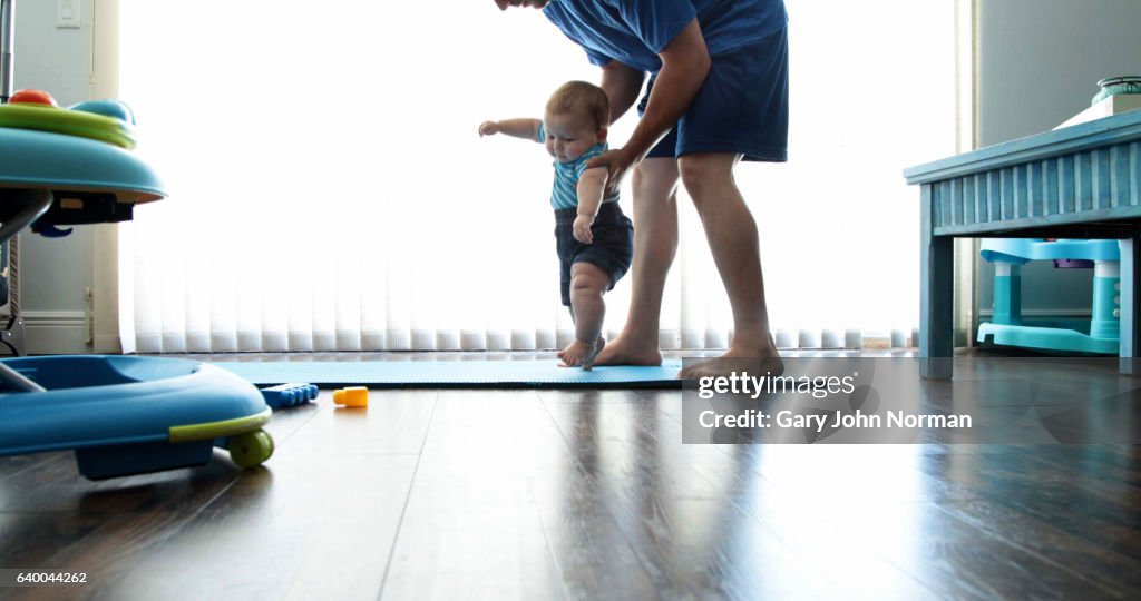 Dad and baby son ( 7-9 months) exercise at home