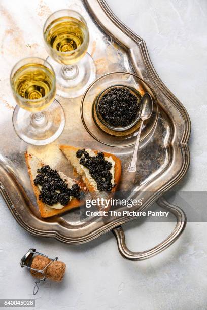 sturgeon black caviar, sandwiches and champagne on silver tray - silbertablett stock-fotos und bilder