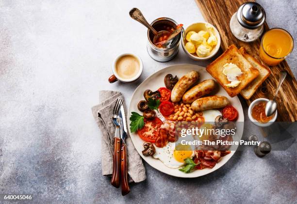 full english breakfast with fried eggs, sausages, bacon, beans, toasts and coffee on copy space background - full english breakfast stock pictures, royalty-free photos & images