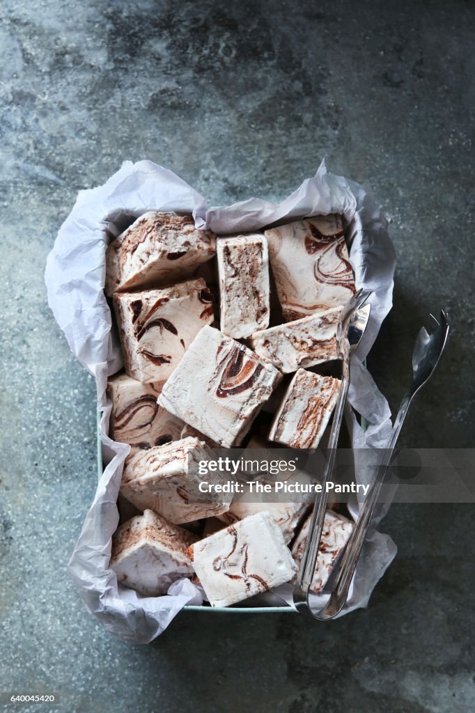 Homemade chocolate swirl marshmallows on a metal box.Top view