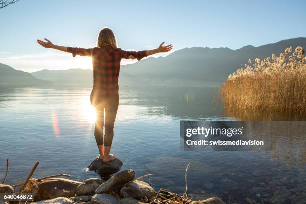 young cheerful woman by the lake enjoying nature - naturopath stock pictures, royalty-free photos & images