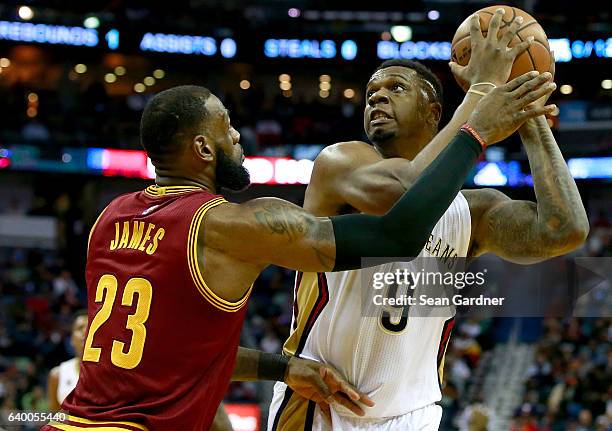 Terrence Jones of the New Orleans Pelicans is defended by LeBron James of the Cleveland Cavaliers during the first half of a game at the Smoothie...