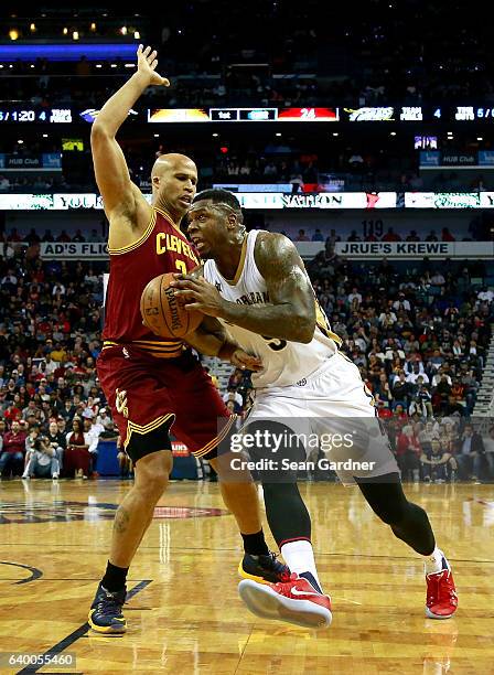 Terrence Jones of the New Orleans Pelicans dribbles the ball past Richard Jefferson of the Cleveland Cavaliers during a game at the Smoothie King...