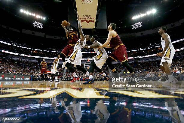Kyrie Irving of the Cleveland Cavaliers shoots over Terrence Jones of the New Orleans Pelicans during a game at the Smoothie King Center on January...