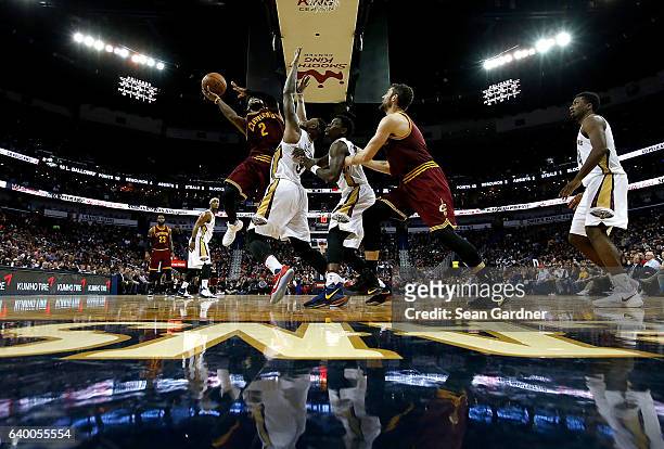 Kyrie Irving of the Cleveland Cavaliers shoots over Terrence Jones of the New Orleans Pelicans during a game at the Smoothie King Center on January...