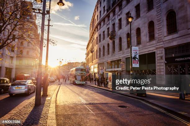 sunset over the strand street - street sunset stock pictures, royalty-free photos & images