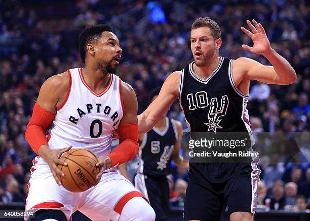 Jared Sullinger of the Toronto Raptors dribbles the ball as David Lee of the San Antonio Spurs defends during the first half of an NBA game at Air...