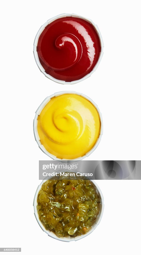 Ketchup, mustard, and relish in paper cups