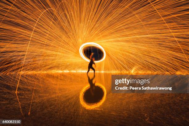 fire steel wool with water reflection - burning steel wool firework stock pictures, royalty-free photos & images