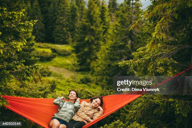 young women in hammock in the mountains - hammock camping stock pictures, royalty-free photos & images