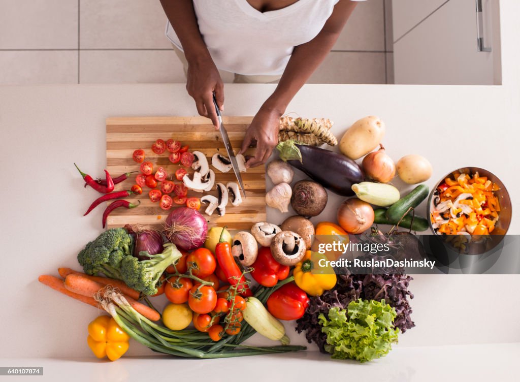 Unrecognized women preparing fresh healthy salad.