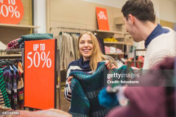 couple laughing and shopping in store - percentage sign stock pictures, royalty-free photos & images