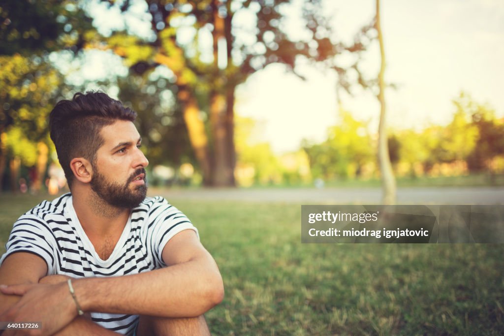 Young man overthinking in the park